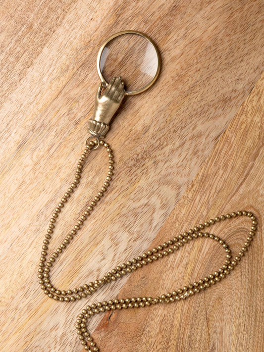 Small hand holding magnifier