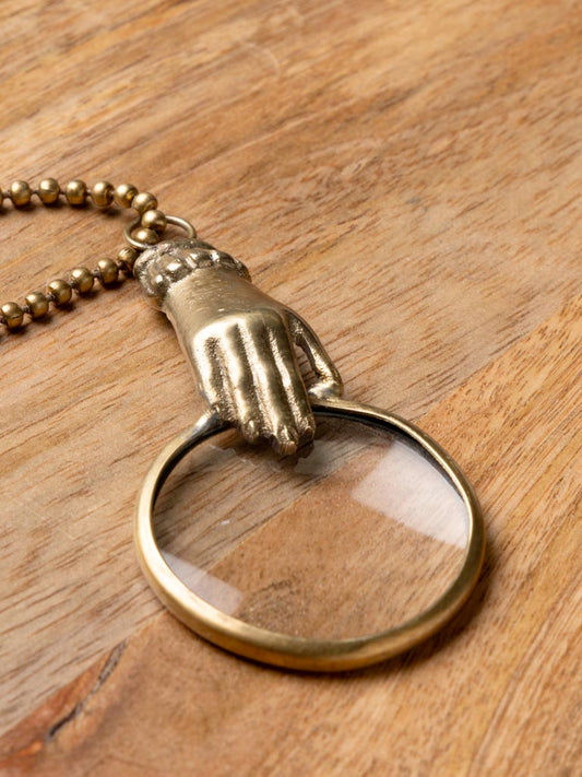 Small hand holding magnifier